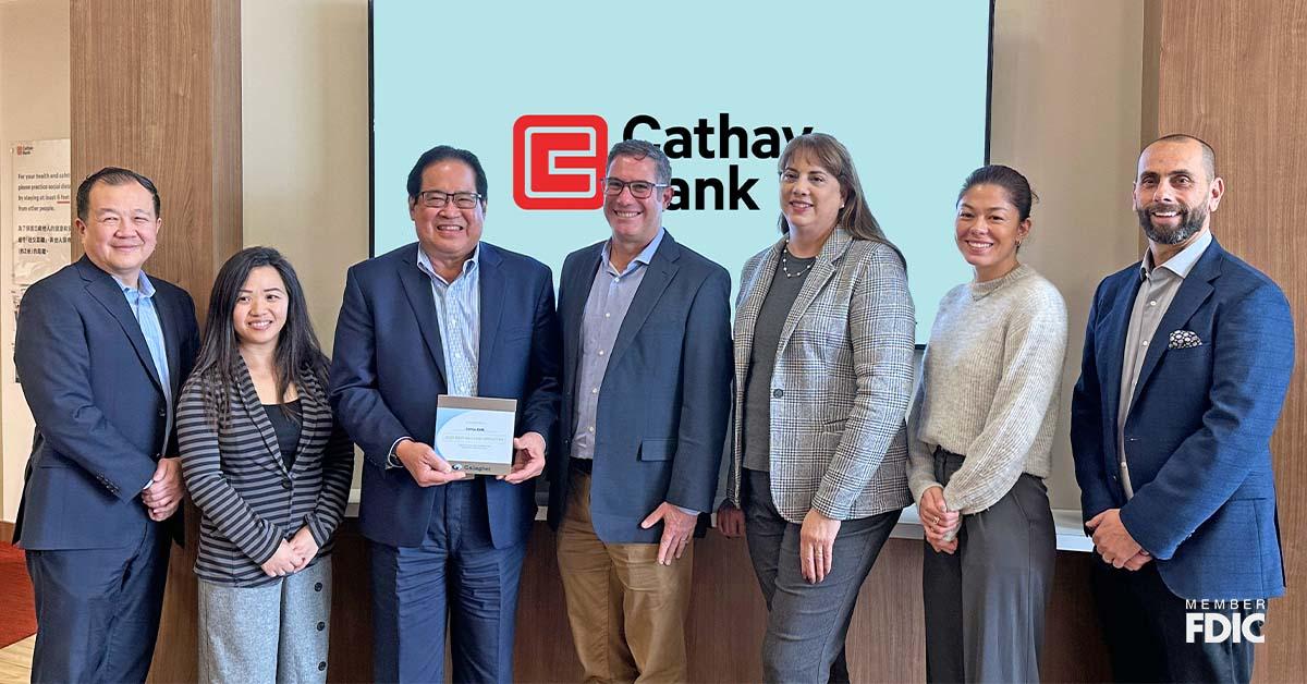 Cathay Bank team members pose with the 2023 Gallagher Award with members from the firm at the Temple City branch in California.