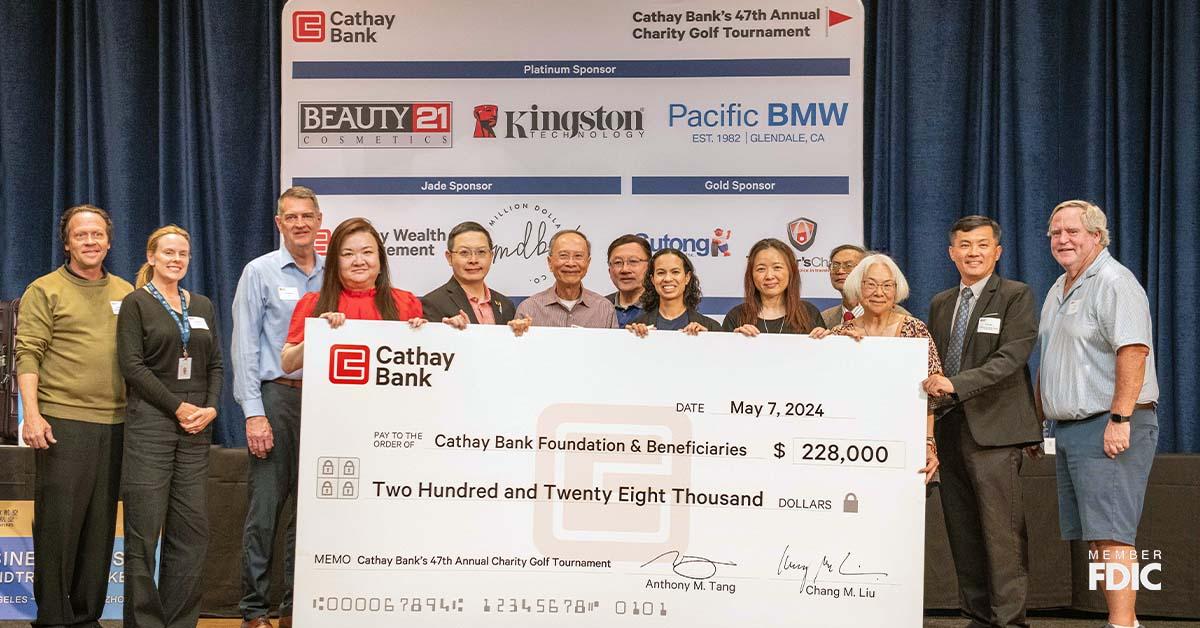 Cathay Bank presents a $228,000 check to representatives from local nonprofits who will benefit from the funds raised at the bank’s golf tournament event.